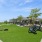 a park with chairs and cornhole