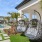 two chairs next to a building and a pool