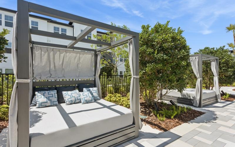 an outdoor lounge are with beds