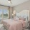 a bedroom with a bed and lamps